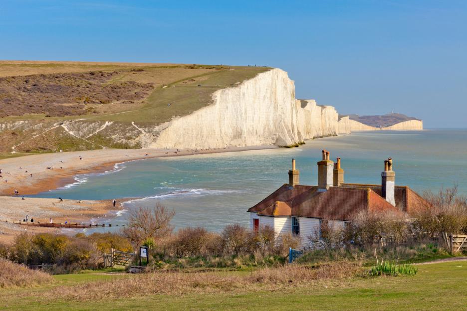 The Seven Sisters chalk cliffs and beach in East Sussex, with Cuckmere Haven in the foreground.