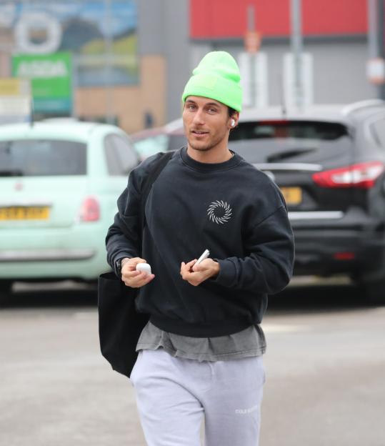 Gorka Marquez in a neon green beanie, black sweatshirt, and light gray sweatpants.
