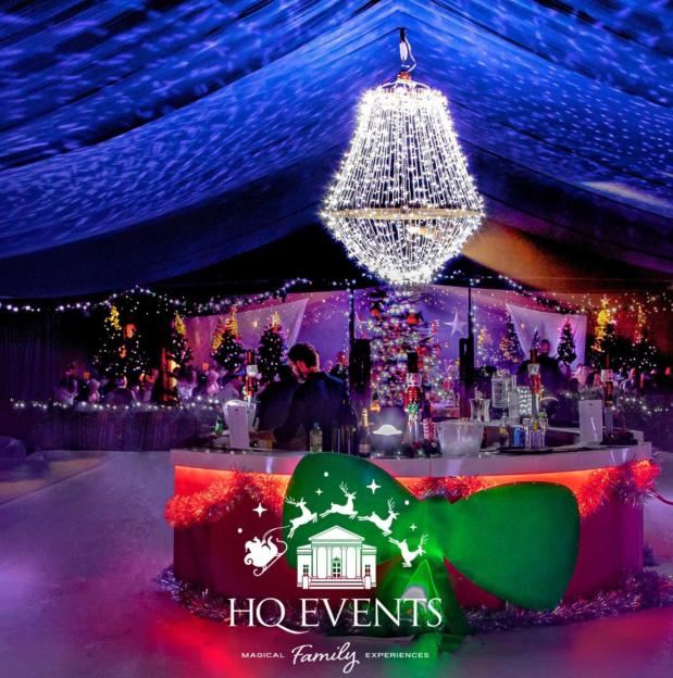 An image for an advert for Winter Wonderland shows a bar in an illuminated tent with Christmas trees.