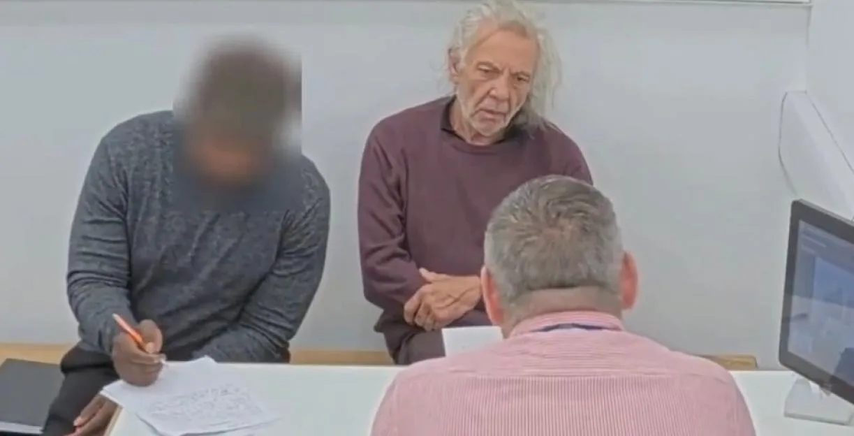 Melvin West, aged 73, sitting at a table during a police interview.