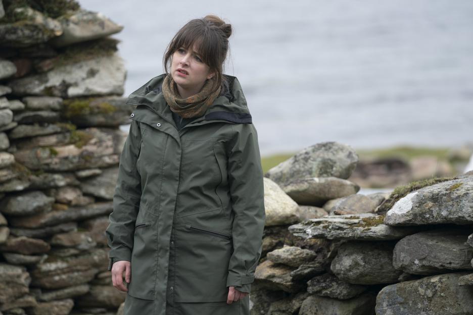 DI Tosh McIntosh, played by Alison O'Donnell, wearing a green coat and scarf.