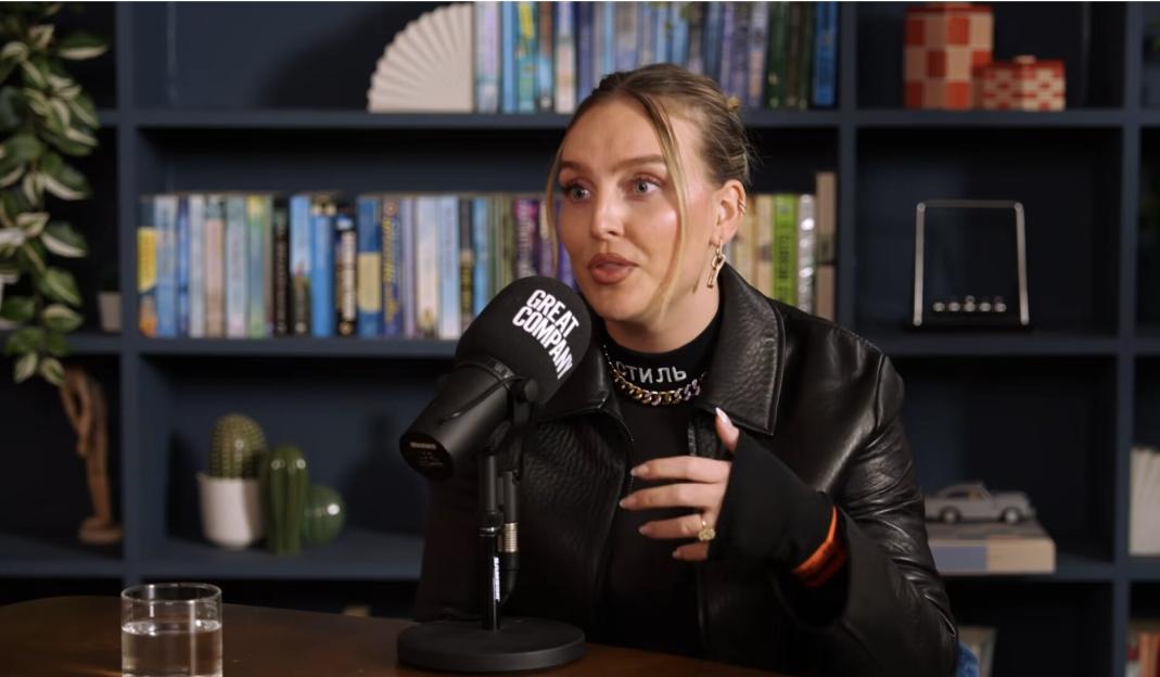 Perrie Edwards speaking into a Great Company microphone.