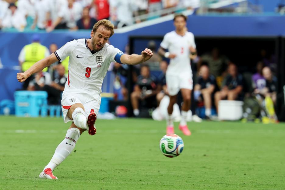 England's Harry Kane takes a shot during a World Cup quarterfinal soccer match.