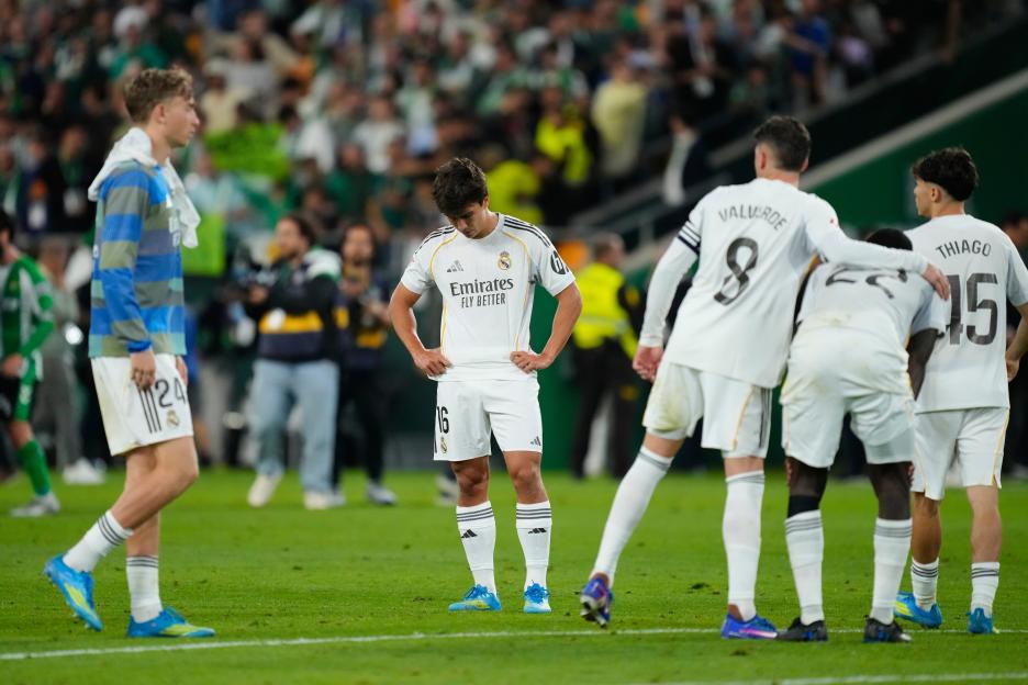 Real Madrid players looking dejected on the field after a La Liga soccer match.