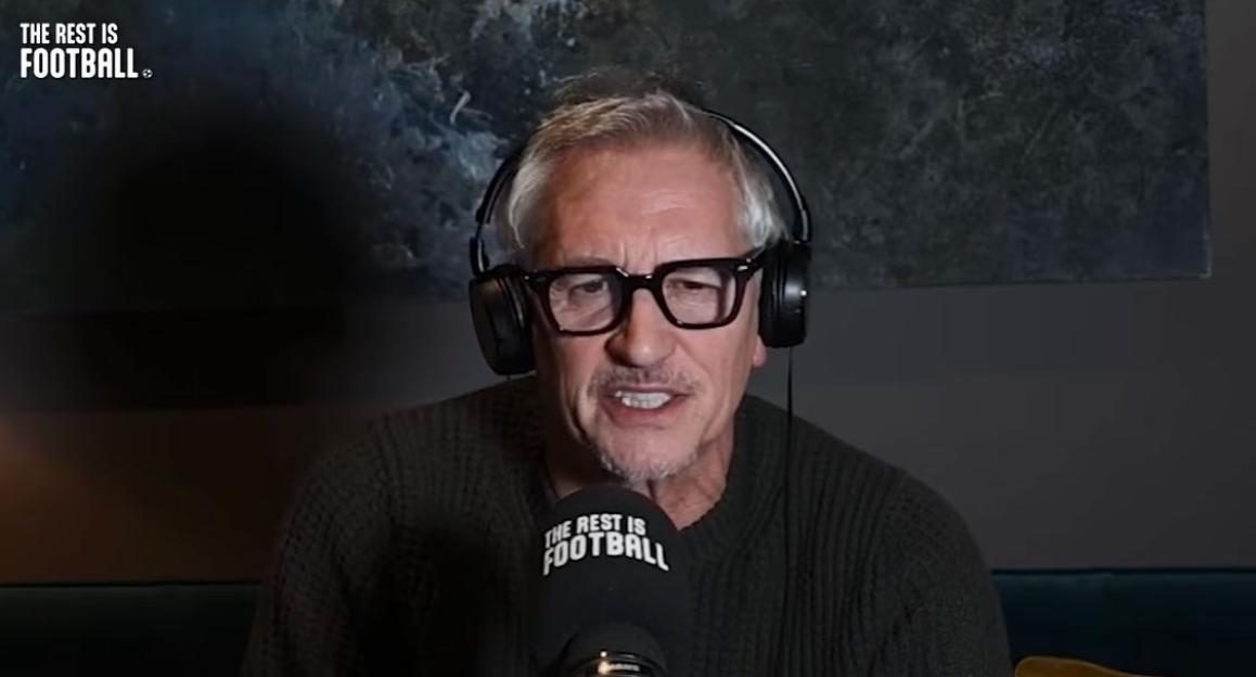 A man wearing headphones and glasses speaks into a microphone.
