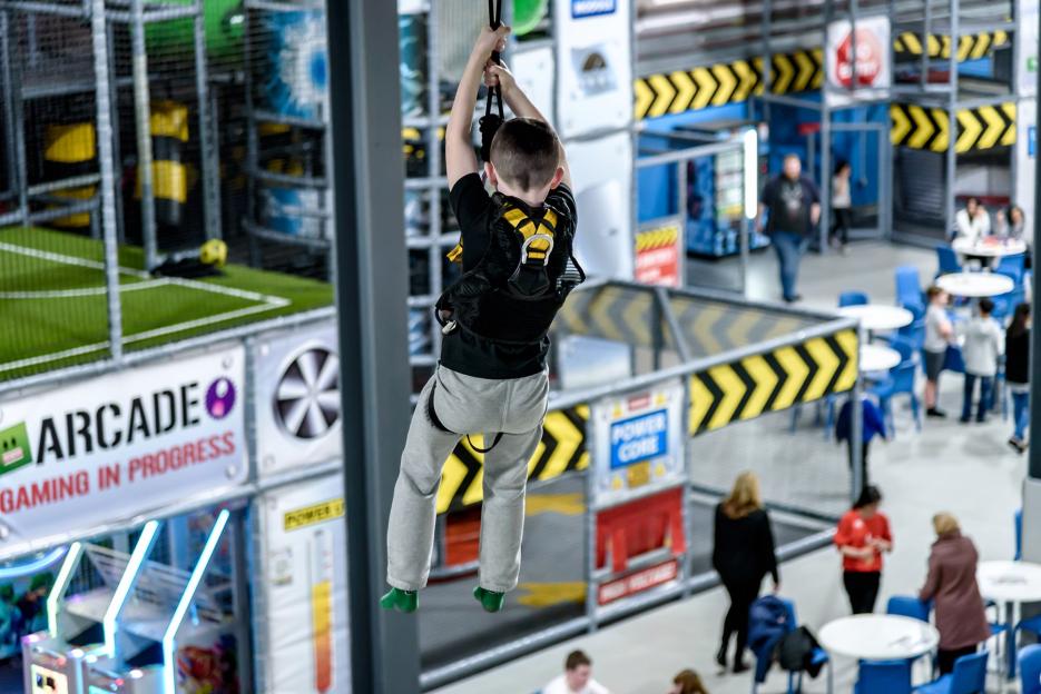 A child on a zip line inside Play Factore, the UK's largest indoor play area.