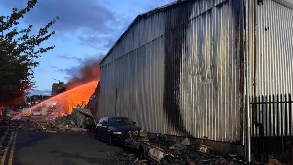 Firefighters battling a large fire at a commercial building in Salford.