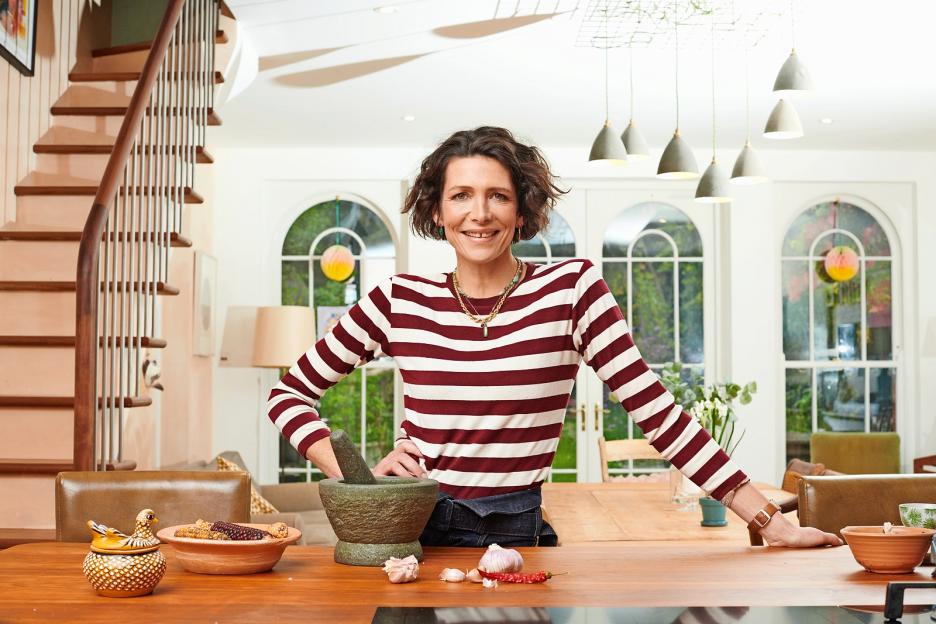 Thomasina Miers at home in London with cooking ingredients on a wooden table.