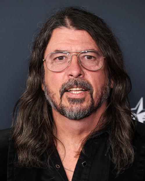 Headshot of Dave Grohl with long hair, glasses, and a beard.