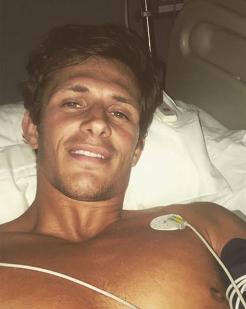 Jake Hall in a hospital bed with medical sensors on his chest.