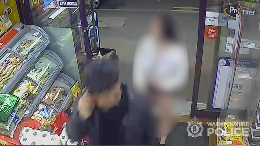 CCTV footage showing a man and a heavily pixelated young person at the entrance of a store.