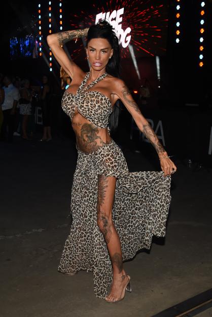 Katie Price posing in a leopard print halter top and matching skirt.
