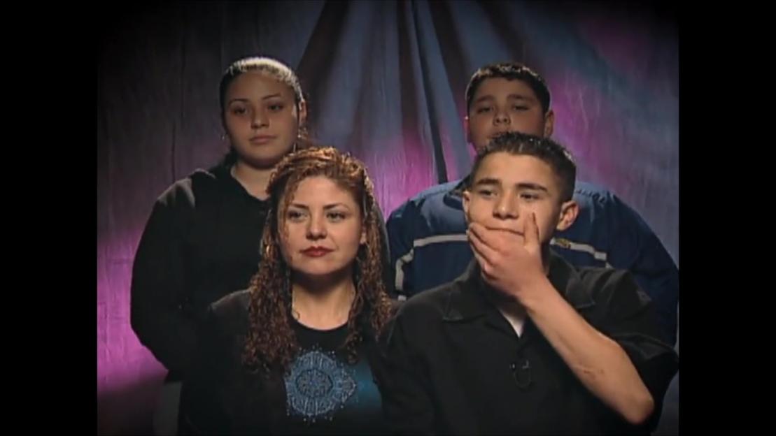 The Arvizo family, with the mother kissing her son, during an interview.