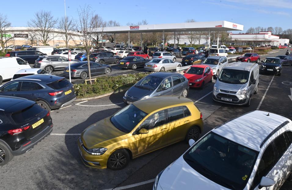 Cars queue up at Costco Manchester for fuel due to a fuel crisis.