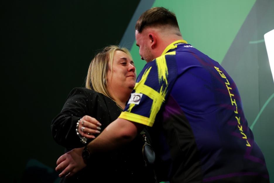 Luke Littler of England embraces his mother Lisa Littler.