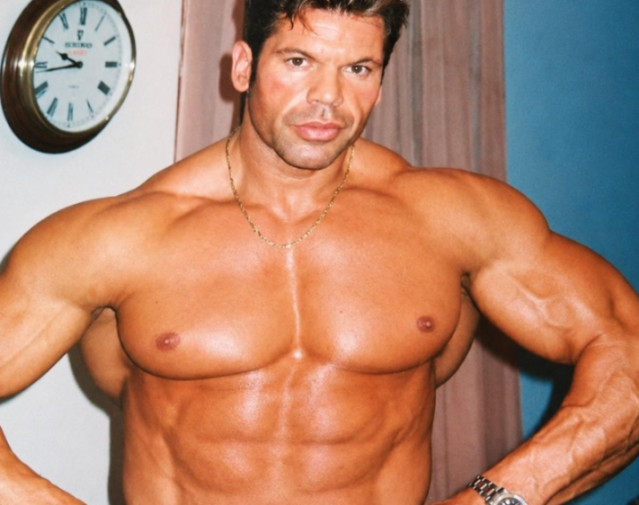 A muscular man with a gold chain around his neck.
