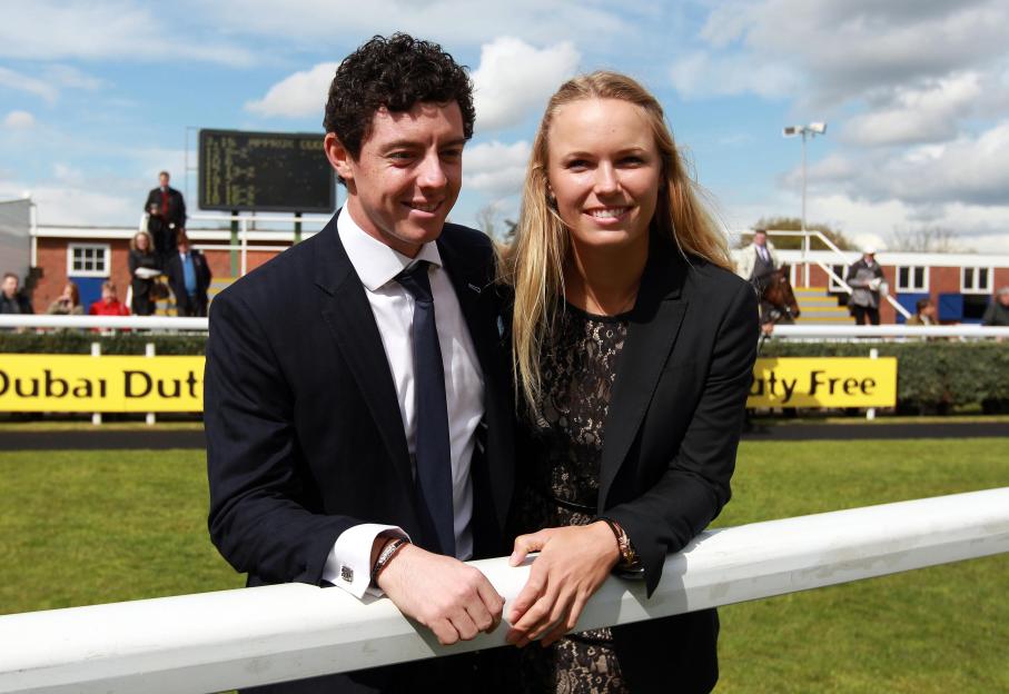 Golfer Rory McIlroy and tennis player Caroline Wozniacki standing at Newbury Racecourse.
