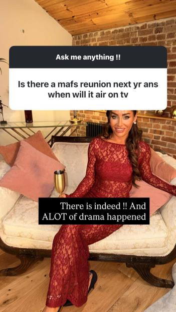 Leisha, in a red lace jumpsuit, sitting on a couch answering a question about a MAFS reunion.
