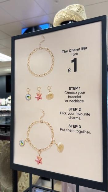 Signage for Primark's Charm Bar, showing how to create a bracelet with charms.