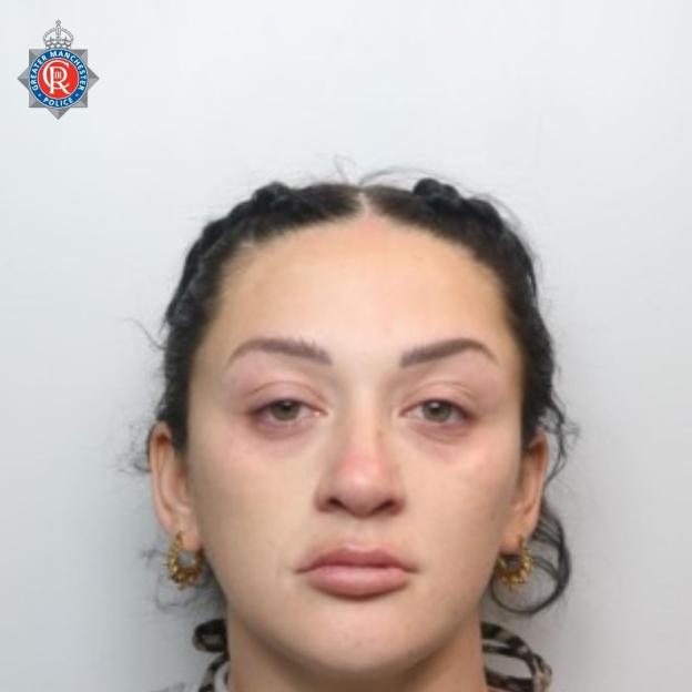 Mugshot of Nicole Hutchinson, a woman with braided hair and hoop earrings, against a plain background with the Greater Manchester Police logo.