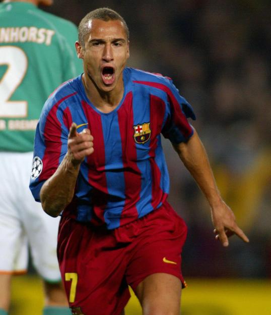 Barcelona's Henrik Larsson celebrating with a pointed finger and open mouth.