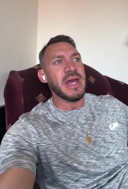 Kirk Norcross sitting in a chair, speaking.