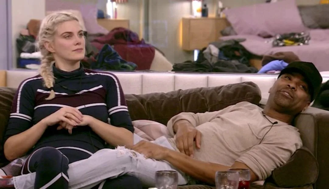 Ashley James and Ginuwine sit together on a sofa in the 'Celebrity Big Brother' house.