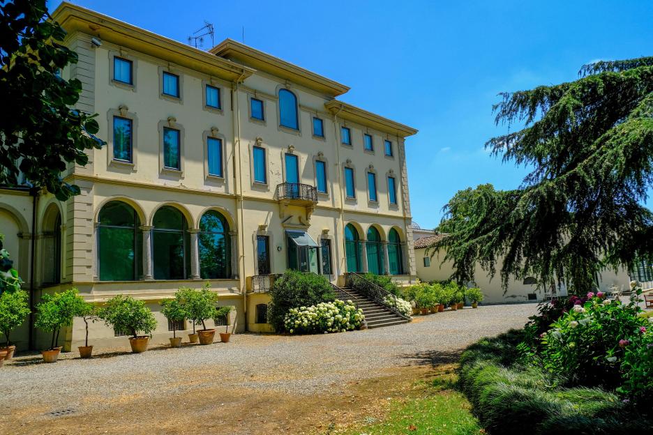 June 2021 Parma, Italy: Fondation Magnani Rocca. Beautiful building of museum, garden with fountains, flowers, trees, and bushes.