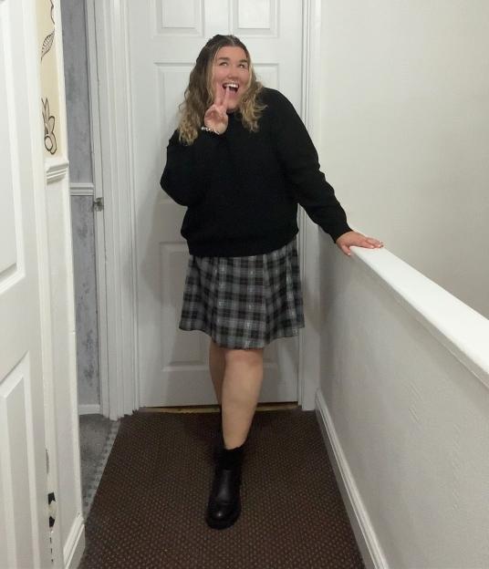 Becki Jones posing with a peace sign gesture.