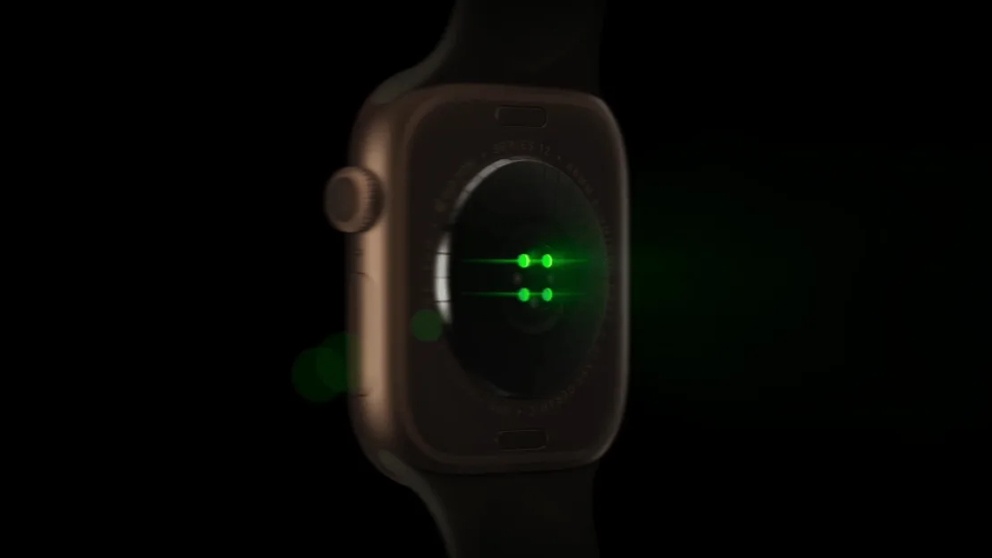 Back view of a smartwatch with glowing green sensors on the rear casing.