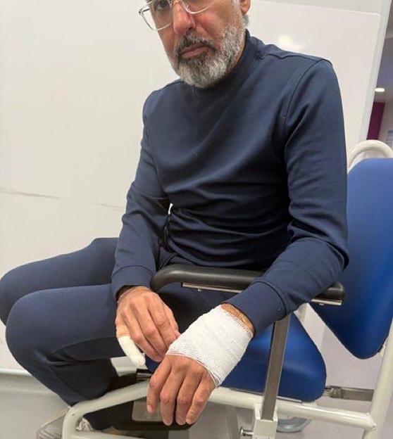 Fawaz Al-Hasawi, former owner of Nottingham Forest FC, sits with a bandaged hand after a home invasion.