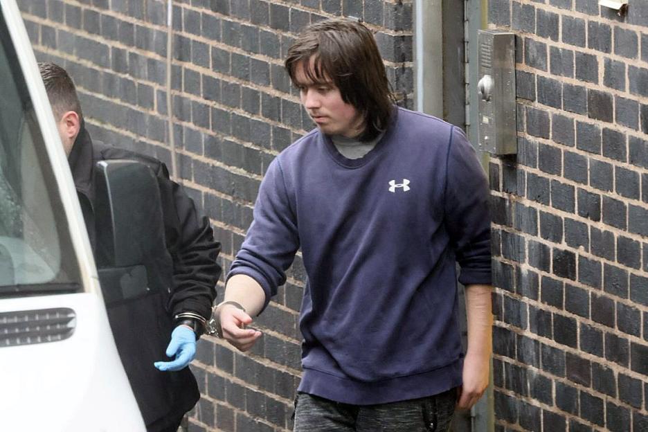 Tristan Thomas Roberts, handcuffed, being led from Mold Crown Court.