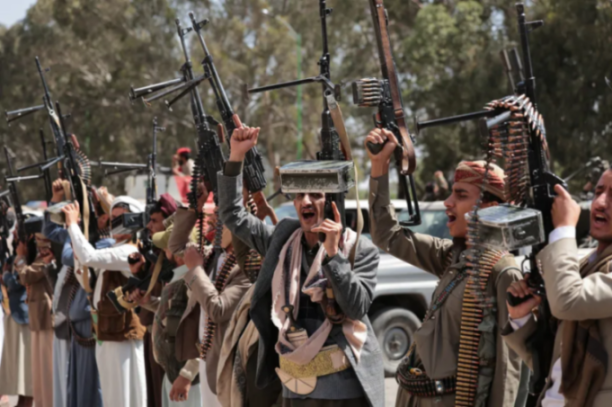 Houthi fighters with rifles and ammunition belts.