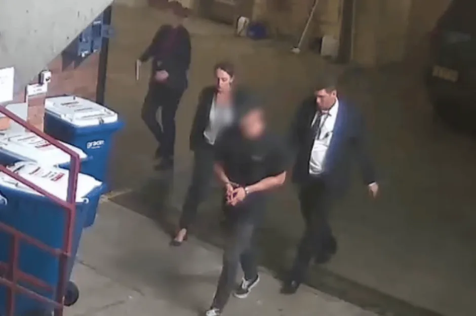 CCTV footage of Beau Lamarre-Condon walking into a police station with his hands cuffed in front of him.