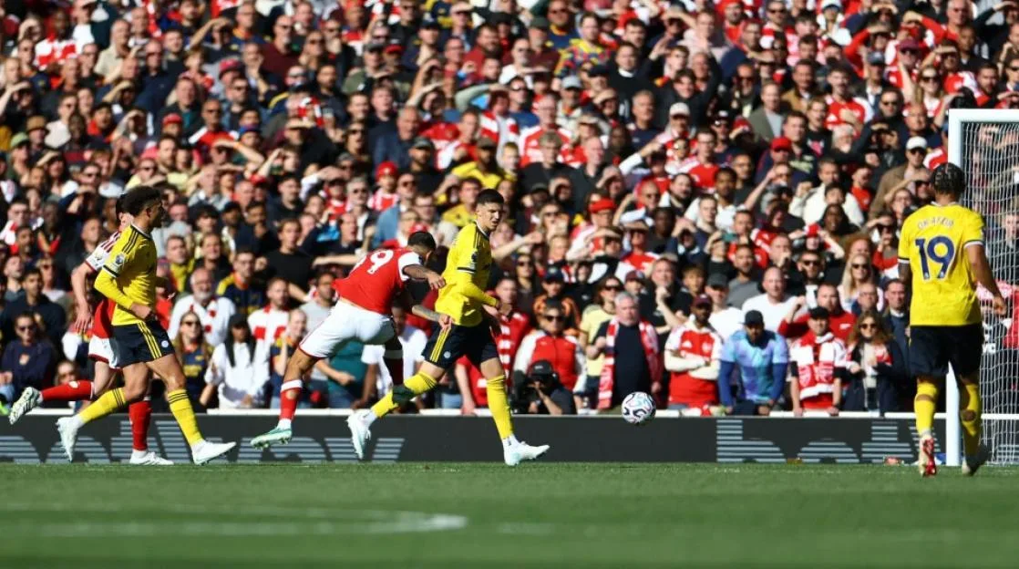 Bruno Guimaraes scores a goal during a Premier League match between Arsenal and Leeds United at Emirates Stadium.