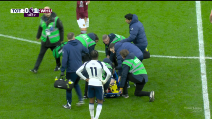 Medical staff attend to an injured player on a stretcher during a soccer match between Tottenham and West Ham.