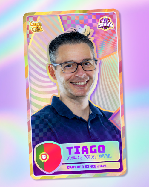 A man in glasses smiling on a Candy Crush All Stars player card with the name Tiago, from Faro, Portugal.