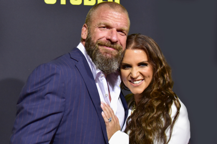 Triple H and Stephanie McMahon smiling together.