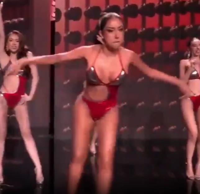 Darathorn Yoothong dancing in a red swimsuit during a pageant.