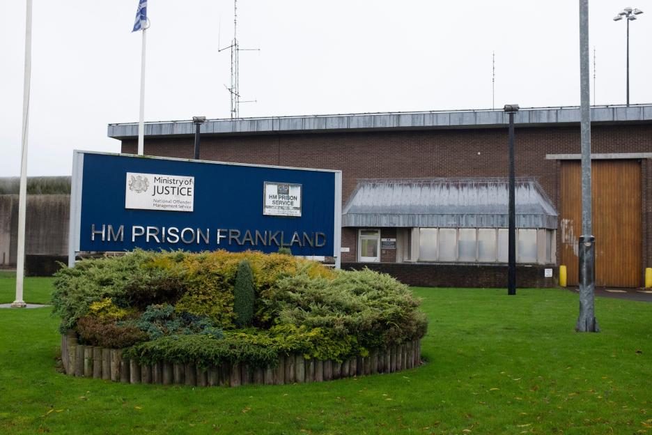 The entrance to HM Prison Frankland with a large blue sign for the Ministry of Justice and HM Prison Service.