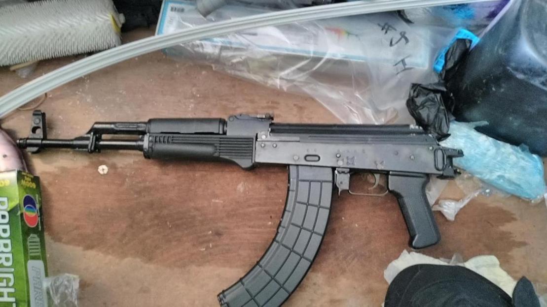 An AK-47 assault rifle with a curved magazine.