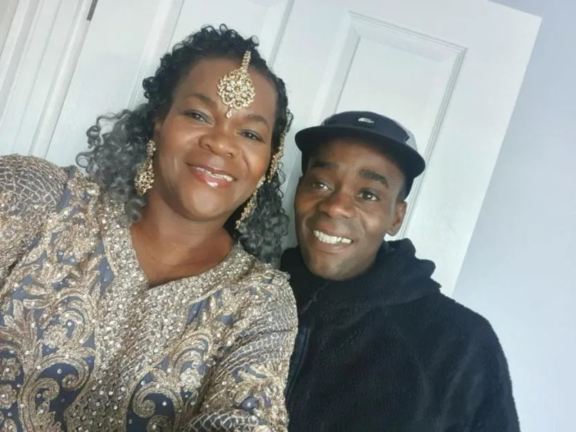 Anton Green with a woman in traditional attire.