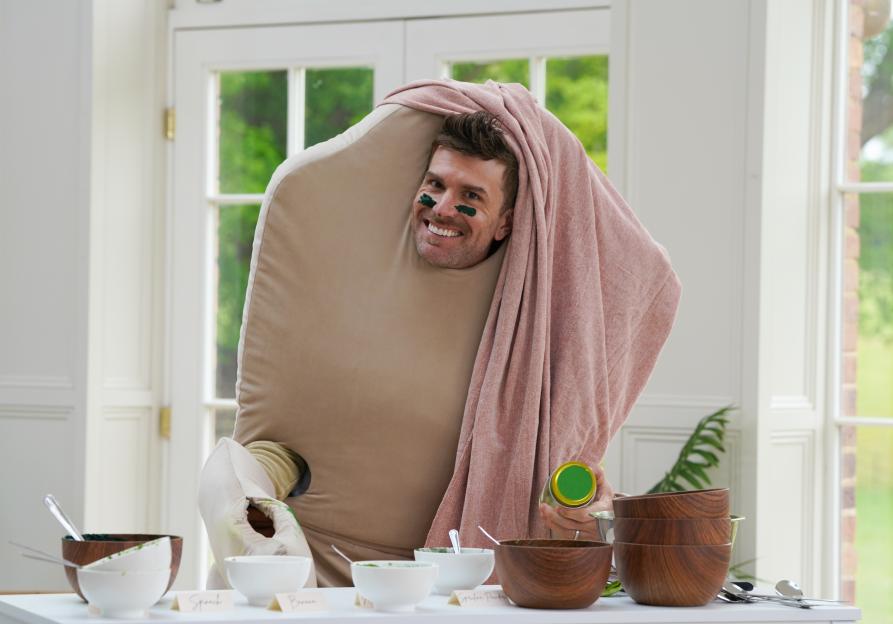 Joel Dommett in a giant pillow costume with green face paint.