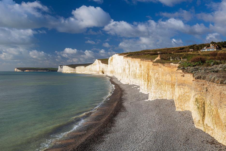 The Birling Gap and the Seven Sisters chalk cliffs on a sunny day.
