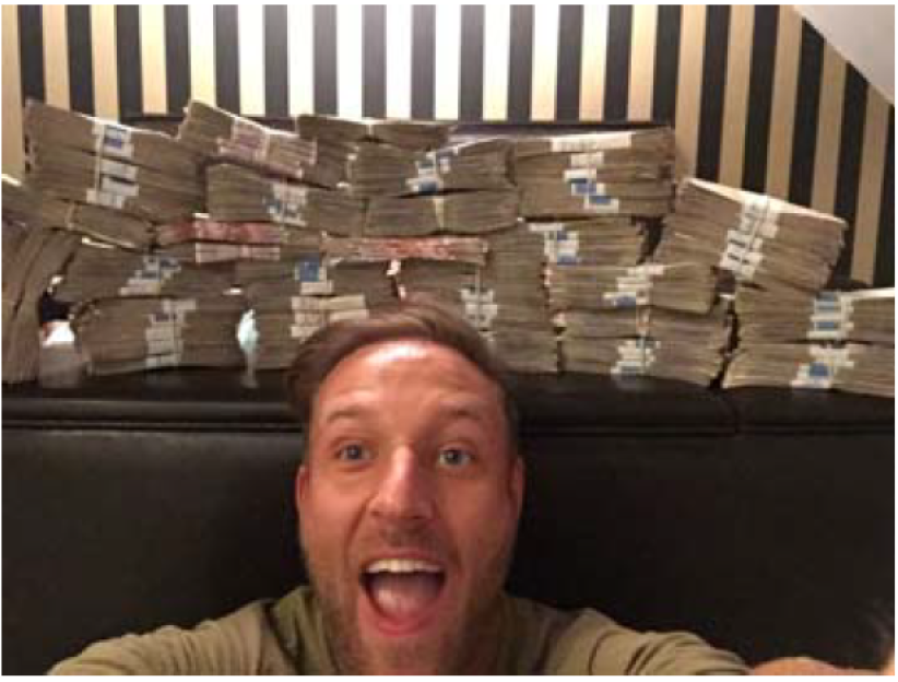 Thomas Richardson poses with cash.