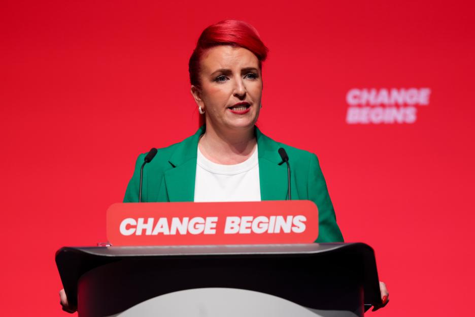 Louise Haigh, UK Transport Secretary, speaking at a podium with "CHANGE BEGINS" on it.
