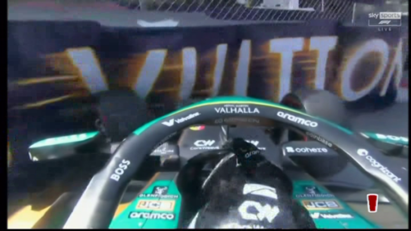 A first-person view from inside a race car, showing the steering wheel and the word "VULTTON" on a wall.