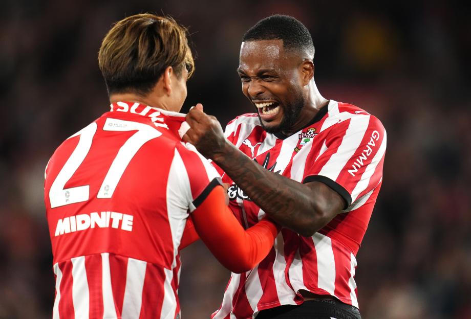 Two Southampton players in red and white striped jerseys celebrating, one with an open-mouthed grin.