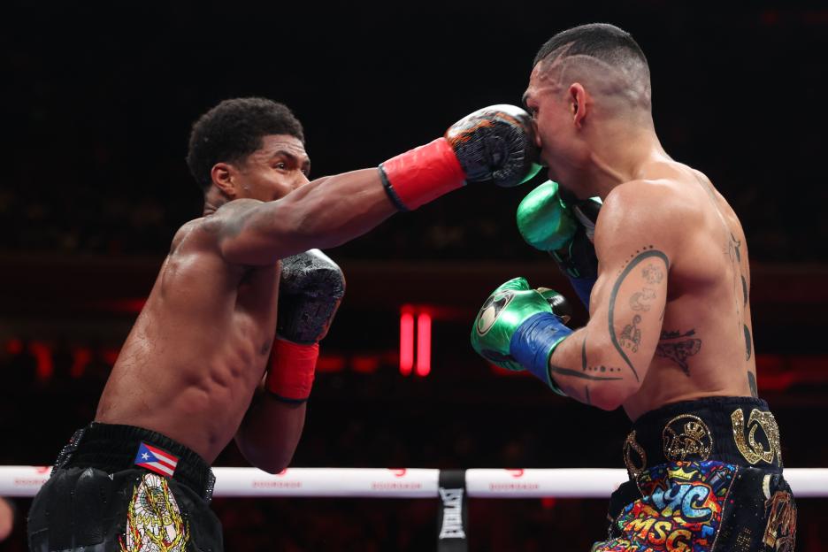 Shakur Stevenson lands a punch on Teofimo Lopez during a boxing match.