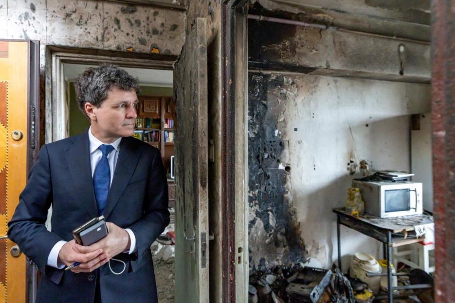 Romanian President Nicusor Dan visits the site of an explosion in a residential block of flats following a reported drone strike in Galati